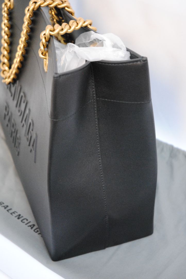Black Balenciaga Medium Shopping Tote in Black Calfskin Leather with Aged Gold Chain, Length: 13.8 in (35 cm) Height: 11.8 in (30 cm) Depth: 5.5 in (14 cm) Strap Drop: 11 in