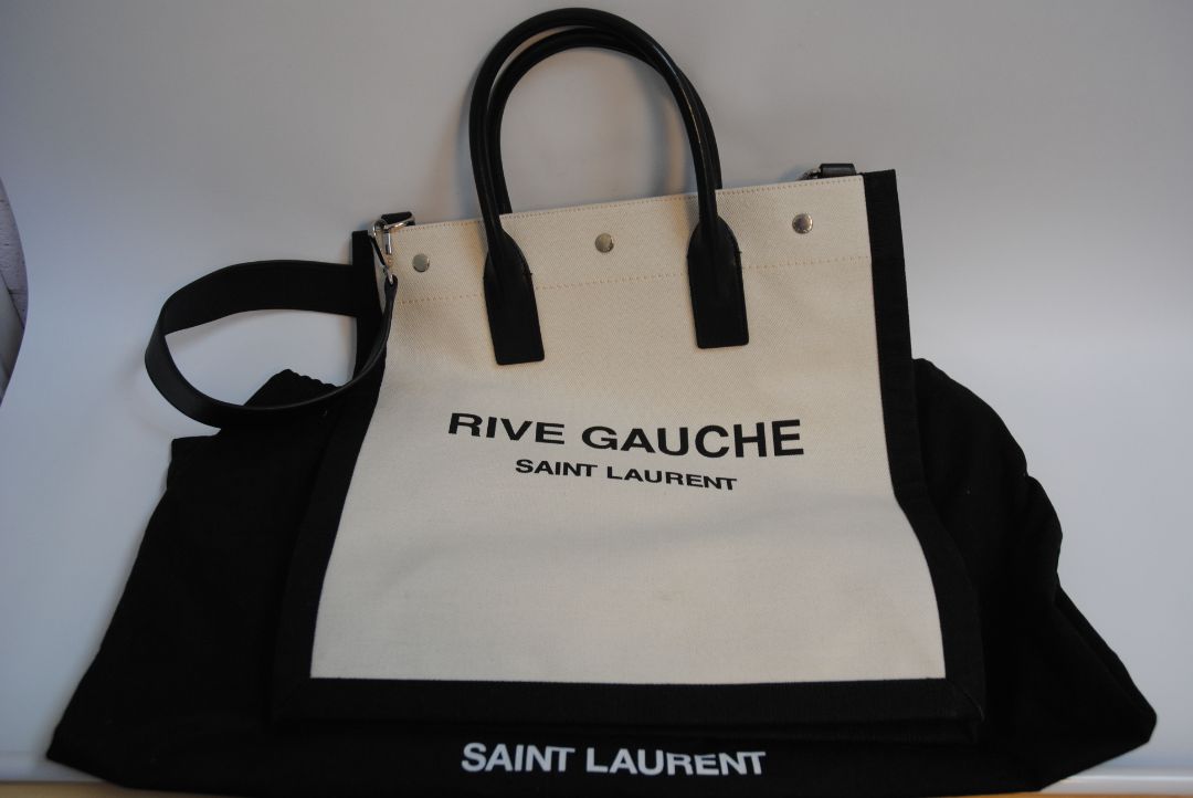 Black and White Yves Saint Laurent Rive Gauche Tote in Canvas and Leather, Length: 18.5 in (47 cm) Height: 14.2 in (36 cm) Width: 6.7 in (17 cm) Strap Drop: 17 in (removable shoulder strap) Handle Drop: 5 in
