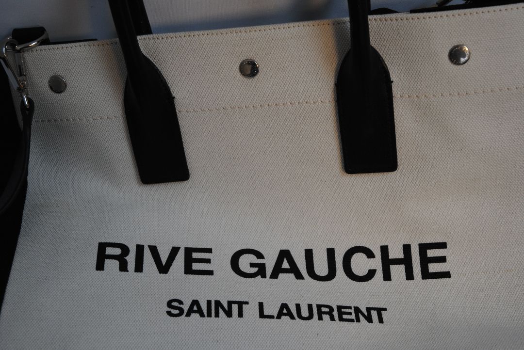 Black and White Yves Saint Laurent Rive Gauche Tote in Canvas and Leather, Length: 18.5 in (47 cm) Height: 14.2 in (36 cm) Width: 6.7 in (17 cm) Strap Drop: 17 in (removable shoulder strap) Handle Drop: 5 in
