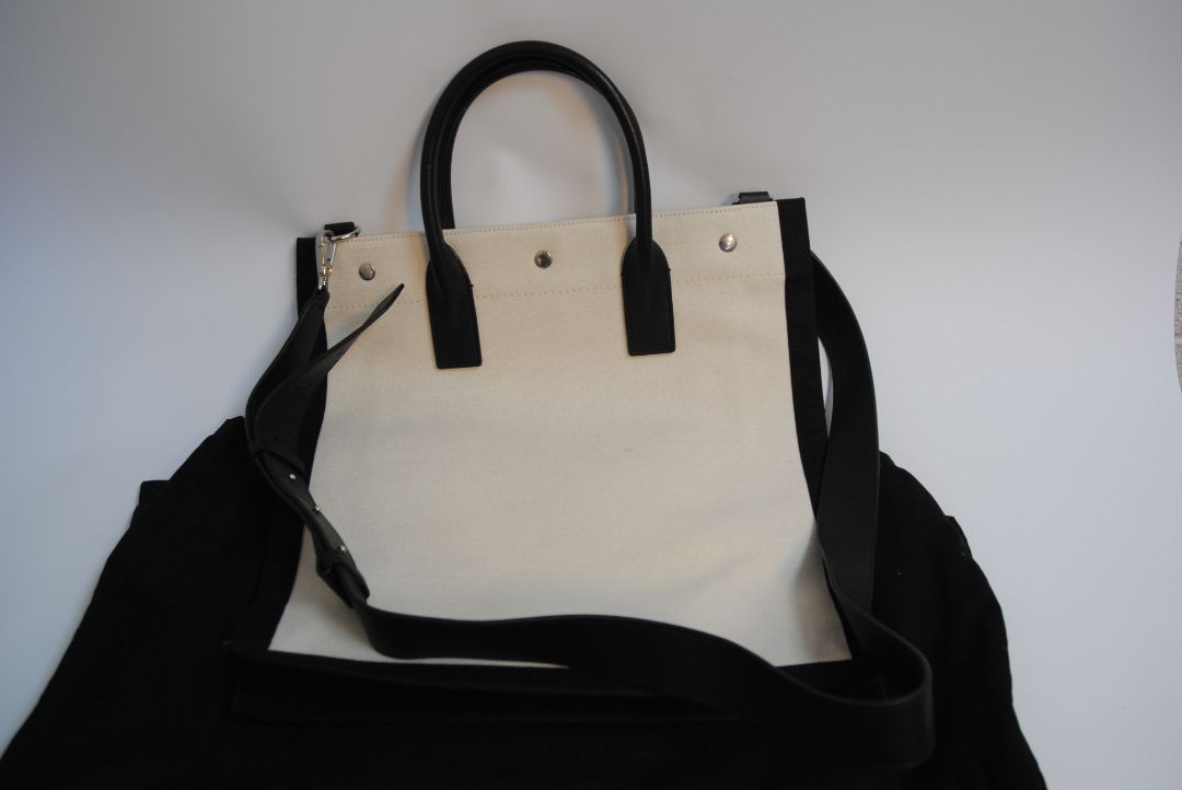 Black and White Yves Saint Laurent Rive Gauche Tote in Canvas and Leather, Length: 18.5 in (47 cm) Height: 14.2 in (36 cm) Width: 6.7 in (17 cm) Strap Drop: 17 in (removable shoulder strap) Handle Drop: 5 in