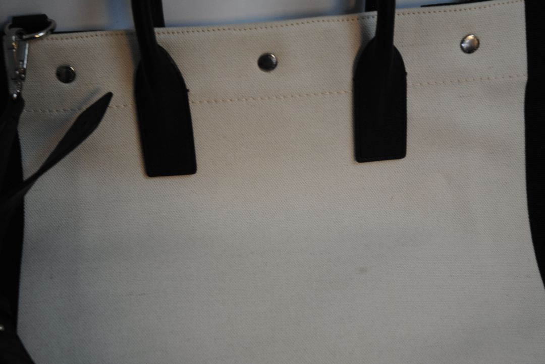 Black and White Yves Saint Laurent Rive Gauche Tote in Canvas and Leather, Length: 18.5 in (47 cm) Height: 14.2 in (36 cm) Width: 6.7 in (17 cm) Strap Drop: 17 in (removable shoulder strap) Handle Drop: 5 in