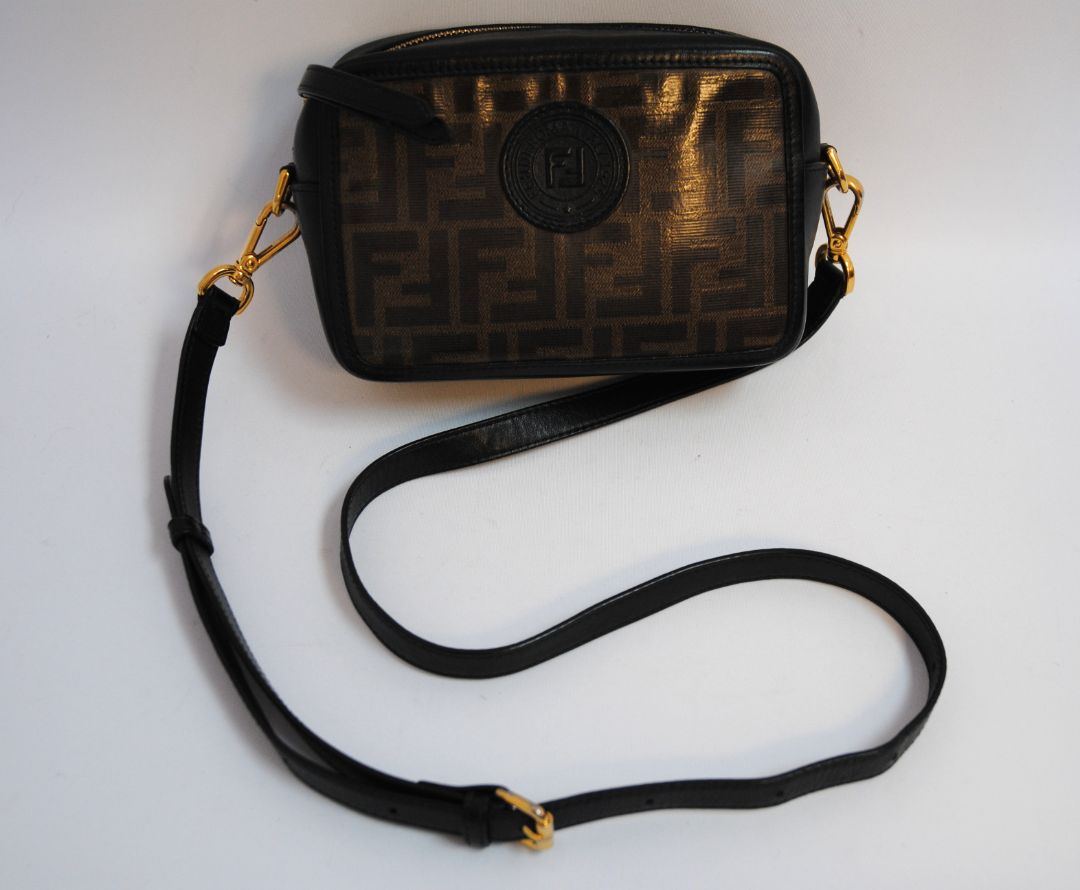 : Brown Zucca monogram Fendi rare Vintage Zucca Crossbody Camera Bag – Brown Canvas with Black Leather Trim, Length: 8.5 in (21.5 cm) Height: 6 in (15 cm) Depth: 2.5 in (6.5 cm) Strap Drop: 21–23 in (adjustable crossbody)