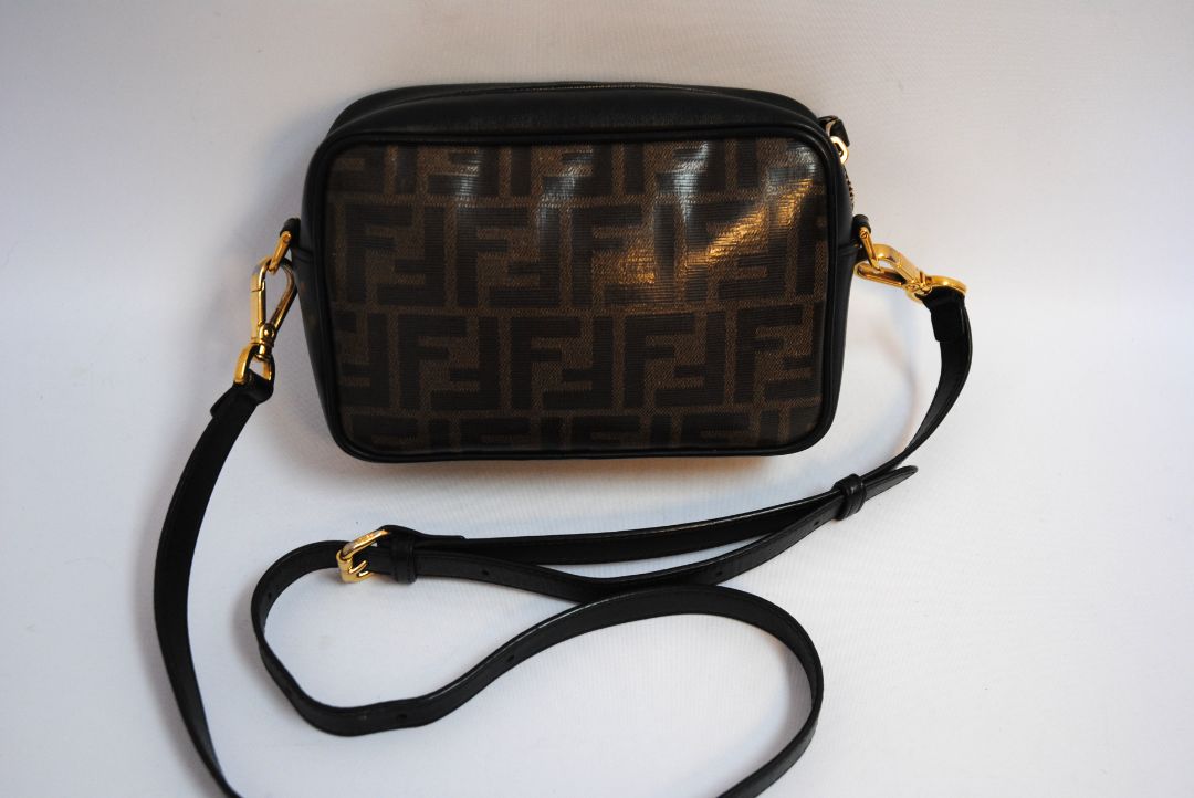 : Brown Zucca monogram Fendi rare Vintage Zucca Crossbody Camera Bag – Brown Canvas with Black Leather Trim, Length: 8.5 in (21.5 cm) Height: 6 in (15 cm) Depth: 2.5 in (6.5 cm) Strap Drop: 21–23 in (adjustable crossbody)