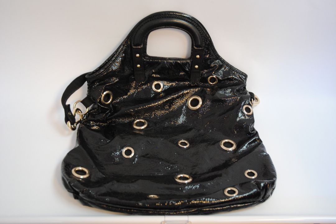black Stella McCartney grommet patent eco tote, Length: 18 in (46 cm) Height: 16 in (41 cm) Depth: 5 in (13 cm) Top Handle Drop: 4 in Shoulder Strap Drop: Adjustable up to 20 in (Ideal for top-handle or crossbody wear)
