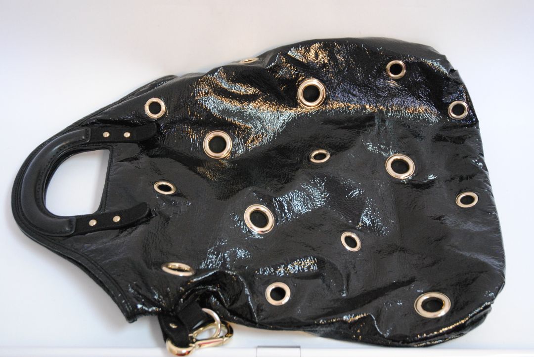 black Stella McCartney grommet patent eco tote, Length: 18 in (46 cm) Height: 16 in (41 cm) Depth: 5 in (13 cm) Top Handle Drop: 4 in Shoulder Strap Drop: Adjustable up to 20 in (Ideal for top-handle or crossbody wear)