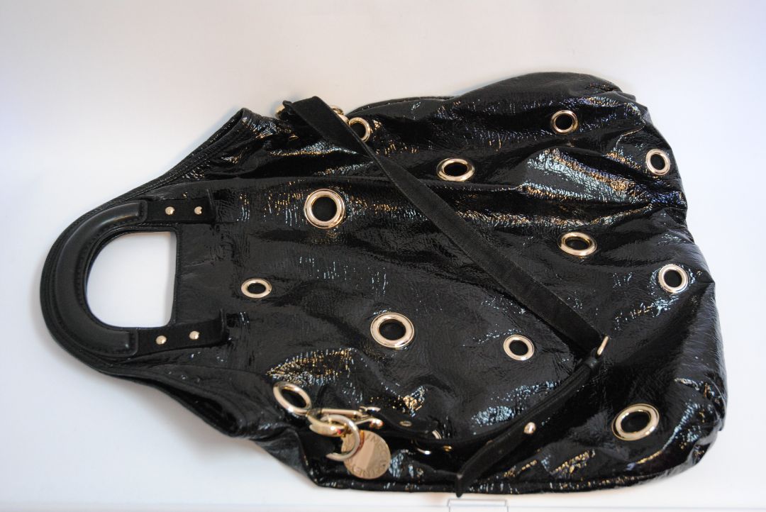 black Stella McCartney grommet patent eco tote, Length: 18 in (46 cm) Height: 16 in (41 cm) Depth: 5 in (13 cm) Top Handle Drop: 4 in Shoulder Strap Drop: Adjustable up to 20 in (Ideal for top-handle or crossbody wear)