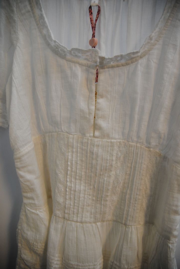 white Love Shack Fancy gwen pintuck dress, Bust: 34 in Waist: 28 in (elastic smocking in back) Length: 31 in (shoulder to hem) Sleeve Length: 10 in Fit: Flowy, relaxed fit with slight empire waist
