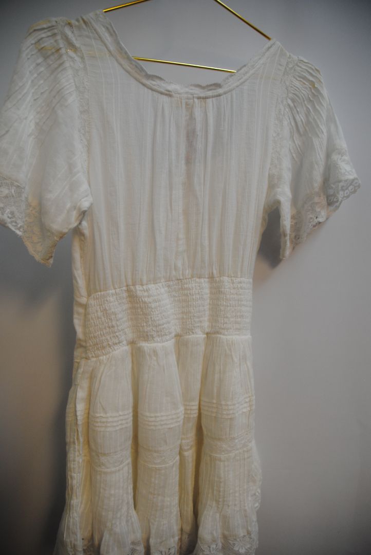 white Love Shack Fancy gwen pintuck dress, Bust: 34 in Waist: 28 in (elastic smocking in back) Length: 31 in (shoulder to hem) Sleeve Length: 10 in Fit: Flowy, relaxed fit with slight empire waist