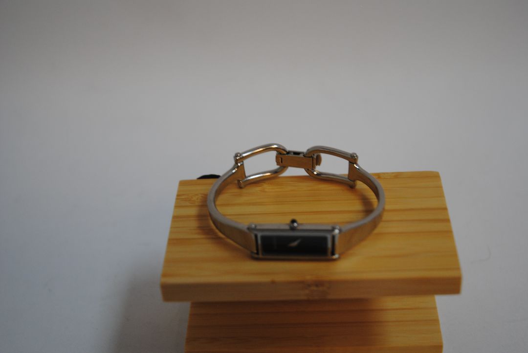 black and silver Gucci rectangle bangle watch, Case Dimensions: Approx. 15 mm width x 35 mm height Band Width: Approx. 10 mm