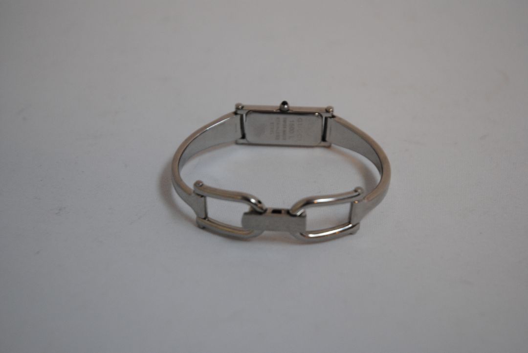 black and silver Gucci rectangle bangle watch, Case Dimensions: Approx. 15 mm width x 35 mm height Band Width: Approx. 10 mm