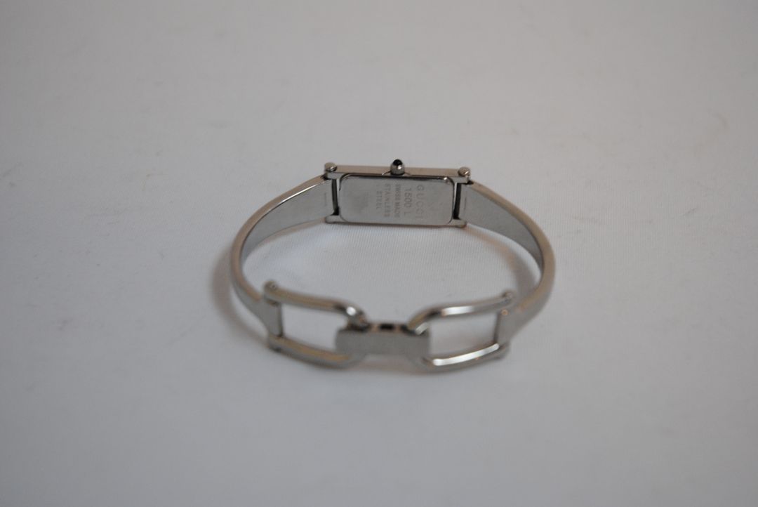 black and silver Gucci rectangle bangle watch, Case Dimensions: Approx. 15 mm width x 35 mm height Band Width: Approx. 10 mm