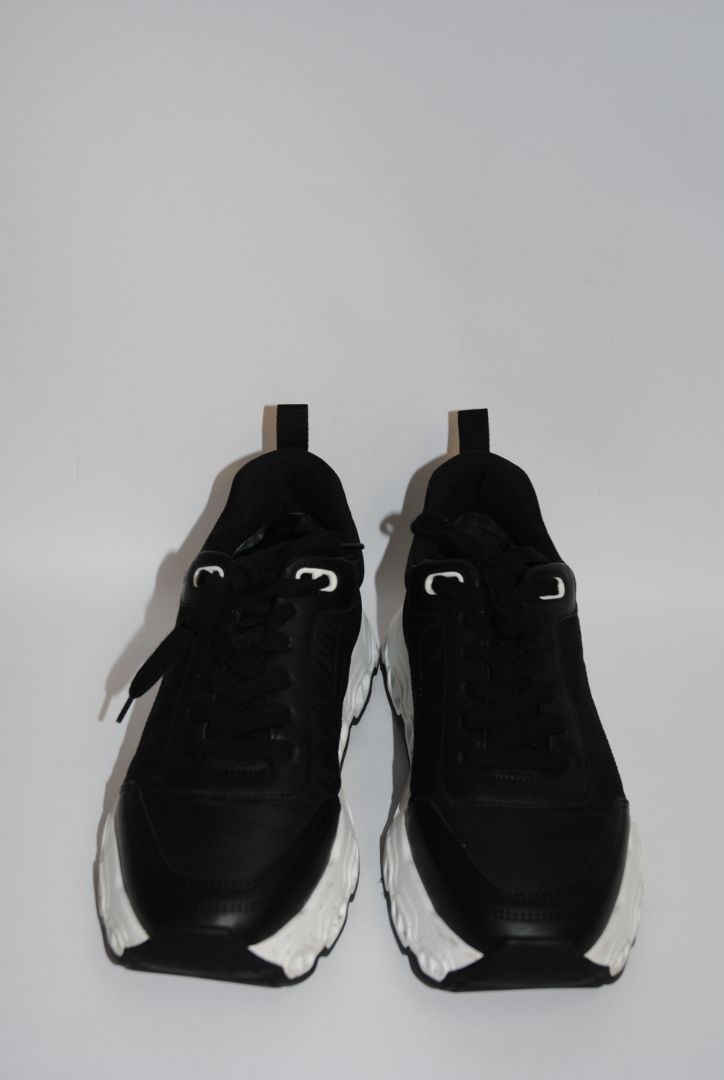 black and white Hermès Bouncing Sneaker, Heel Height: 1.5 in Platform: 1.25 in Fit: True to size (standard men’s sizing; this appears to be ~EU 41–43) Weight: Lightweight EVA sole (typical of Bouncing/Trail line)