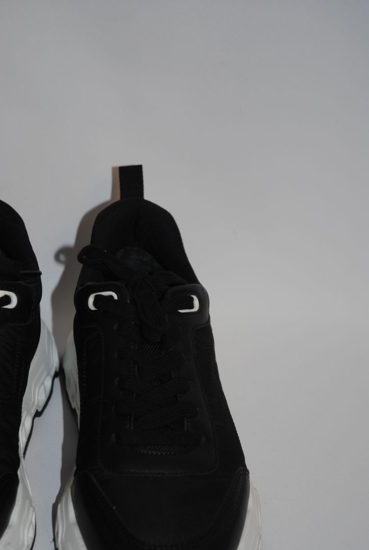 black and white Hermès Bouncing Sneaker, Heel Height: 1.5 in Platform: 1.25 in Fit: True to size (standard men’s sizing; this appears to be ~EU 41–43) Weight: Lightweight EVA sole (typical of Bouncing/Trail line)