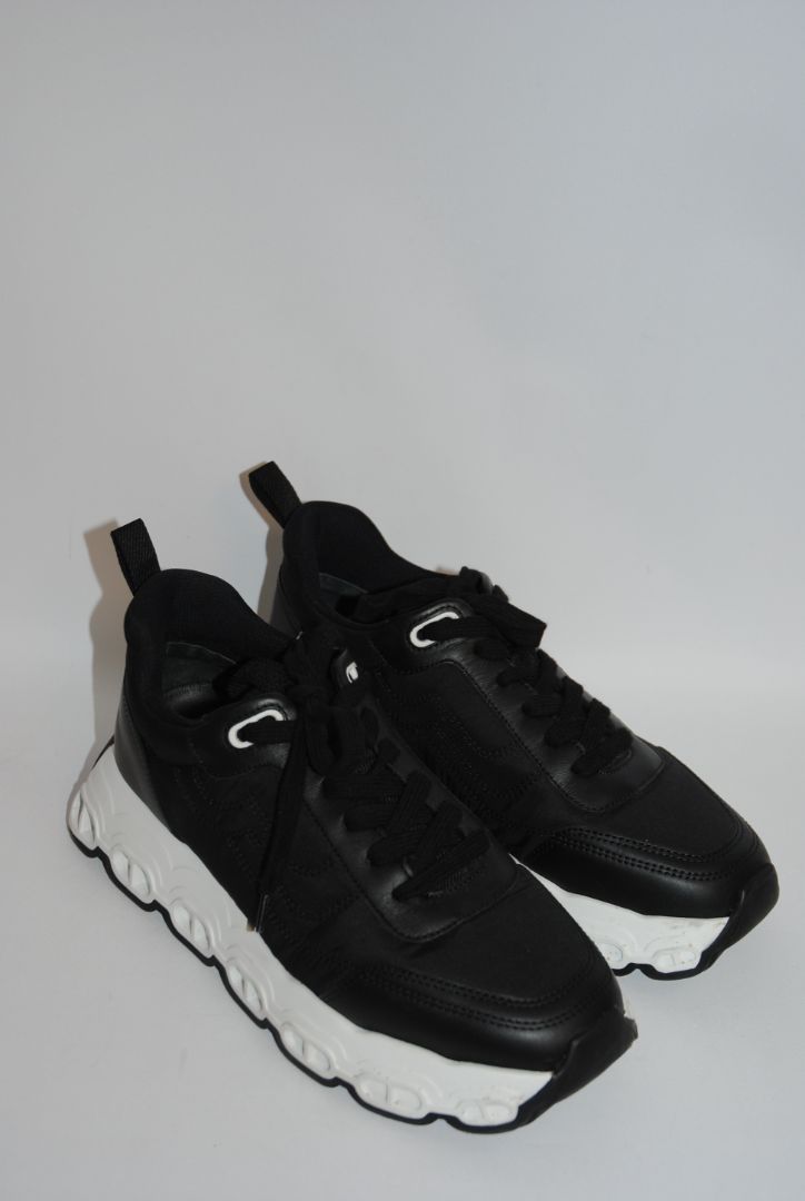 black and white Hermès Bouncing Sneaker, Heel Height: 1.5 in Platform: 1.25 in Fit: True to size (standard men’s sizing; this appears to be ~EU 41–43) Weight: Lightweight EVA sole (typical of Bouncing/Trail line)
