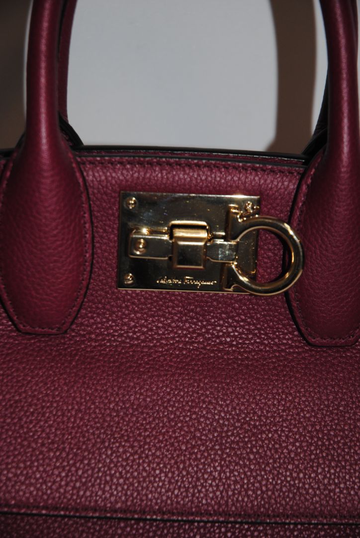 deep raspberry Salvatore Ferragamo Gancini top handle cross body, Length: 10.5 in Height: 8.25 in Depth: 5 in Top Handle Drop: 4 in Strap Drop: Adjustable, approx. 18β22 in