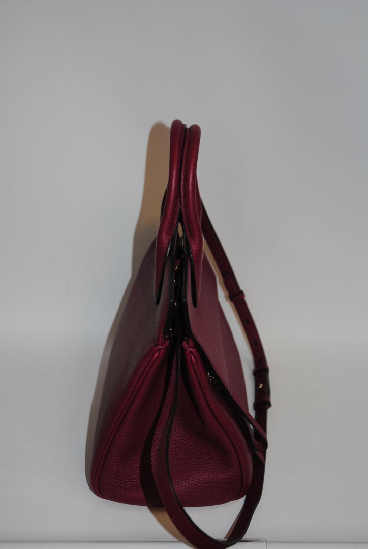 deep raspberry Salvatore Ferragamo Gancini top handle cross body, Length: 10.5 in Height: 8.25 in Depth: 5 in Top Handle Drop: 4 in Strap Drop: Adjustable, approx. 18β22 in