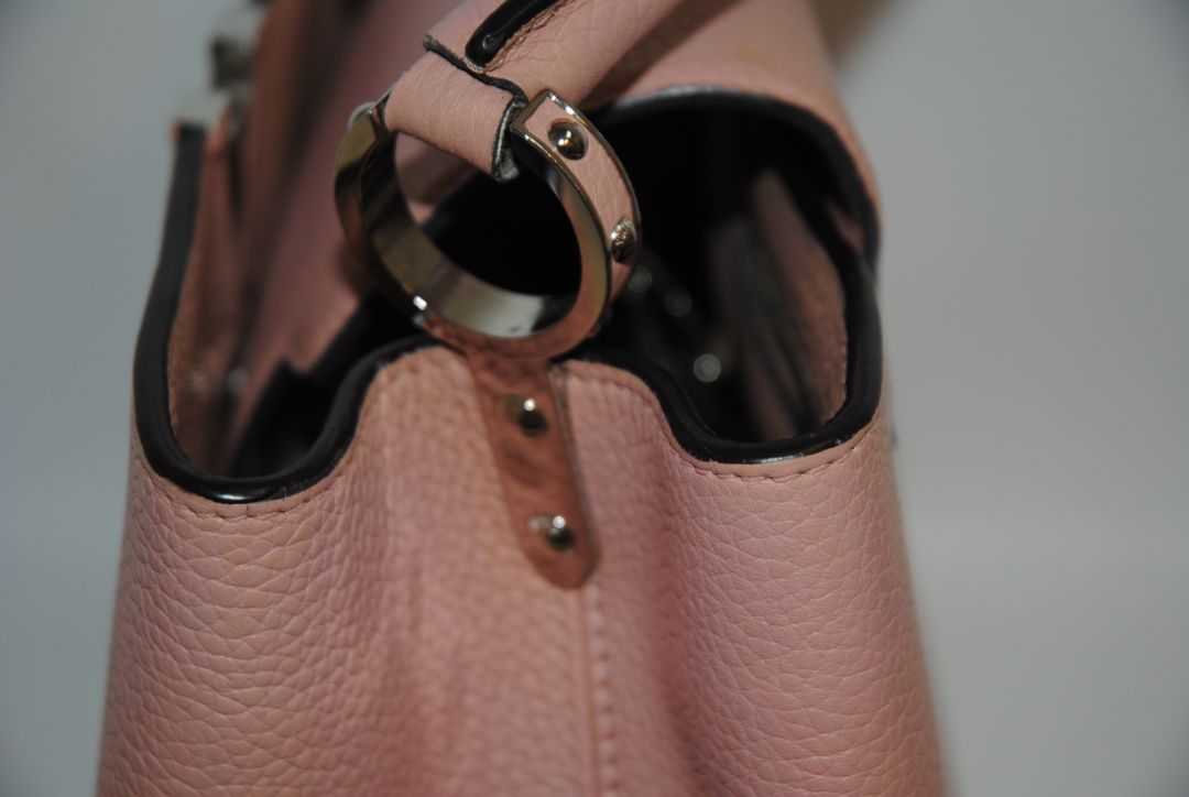 Magnolia Pink Louis Vuitton Capucines BB β Magnolia Pink Taurillon Leather with Silver Hardware, Length: 10.6 in (27 cm) Height: 7 in (18 cm) Depth: 3.5 in (9 cm) Top Handle Drop: 3.5 in (9 cm) Strap Drop: 18β21 in (adjustable/removable)