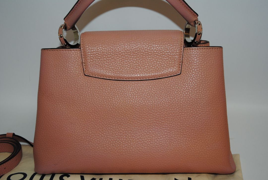 Magnolia Pink Louis Vuitton Capucines BB β Magnolia Pink Taurillon Leather with Silver Hardware, Length: 10.6 in (27 cm) Height: 7 in (18 cm) Depth: 3.5 in (9 cm) Top Handle Drop: 3.5 in (9 cm) Strap Drop: 18β21 in (adjustable/removable)