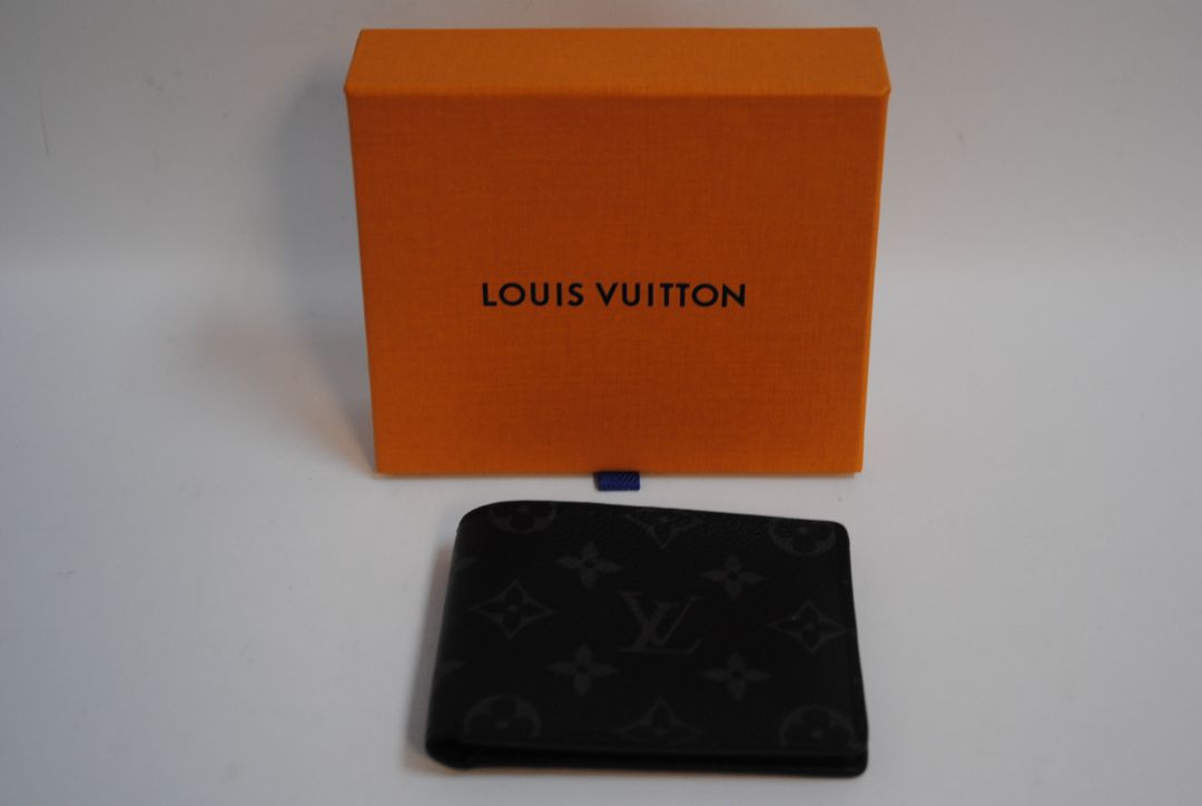 Exterior: Monogram Eclipse canvas (black with dark grey monogram pattern) Interior: Black leather Louis Vuitton Multiple Wallet in Monogram Eclipse Canvas, Length: 4.5 in (11.5 cm) Height: 3.5 in (9 cm) Depth: 0.6 in (1.5 cm)