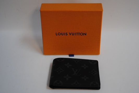 Exterior: Monogram Eclipse canvas (black with dark grey monogram pattern) Interior: Black leather Louis Vuitton Multiple Wallet in Monogram Eclipse Canvas, Length: 4.5 in (11.5 cm) Height: 3.5 in (9 cm) Depth: 0.6 in (1.5 cm)
