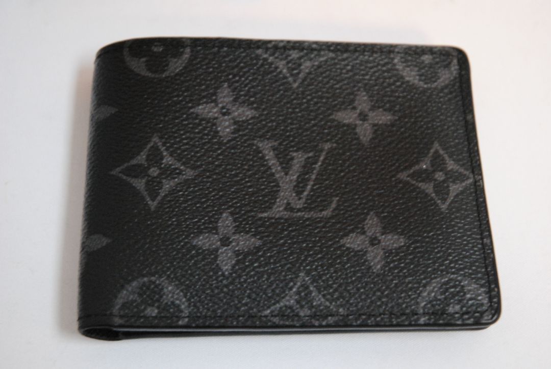 Exterior: Monogram Eclipse canvas (black with dark grey monogram pattern) Interior: Black leather Louis Vuitton Multiple Wallet in Monogram Eclipse Canvas, Length: 4.5 in (11.5 cm) Height: 3.5 in (9 cm) Depth: 0.6 in (1.5 cm)