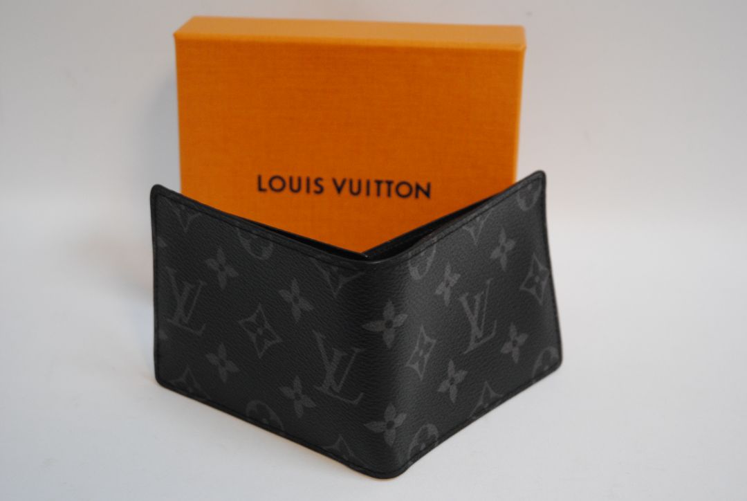 Exterior: Monogram Eclipse canvas (black with dark grey monogram pattern) Interior: Black leather Louis Vuitton Multiple Wallet in Monogram Eclipse Canvas, Length: 4.5 in (11.5 cm) Height: 3.5 in (9 cm) Depth: 0.6 in (1.5 cm)