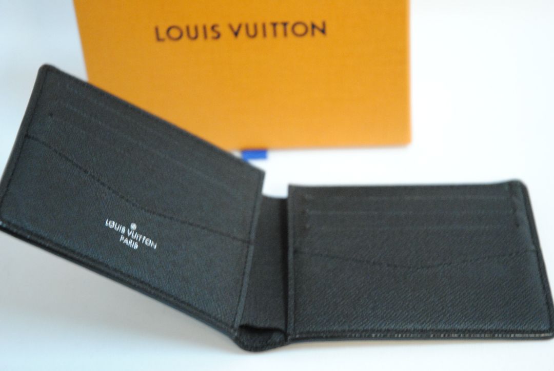 Exterior: Monogram Eclipse canvas (black with dark grey monogram pattern) Interior: Black leather Louis Vuitton Multiple Wallet in Monogram Eclipse Canvas, Length: 4.5 in (11.5 cm) Height: 3.5 in (9 cm) Depth: 0.6 in (1.5 cm)