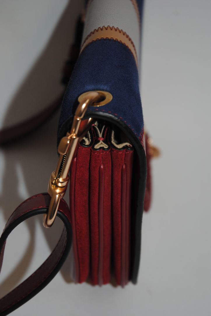 Body: Navy blue suede Trim & Strap: Burgundy and camel-toned smooth leather See by Chloe Hana Small Saddle Bag, Width: 7.5 in (19 cm) Height: 6.5 in (16.5 cm) Depth: 2.75 in (7 cm) Strap Drop: Adjustable up to approx. 22 in (crossbody length)