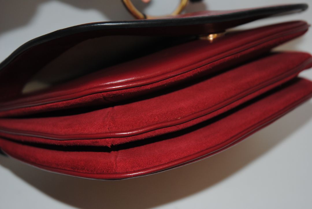 Body: Navy blue suede Trim & Strap: Burgundy and camel-toned smooth leather See by Chloe Hana Small Saddle Bag, Width: 7.5 in (19 cm) Height: 6.5 in (16.5 cm) Depth: 2.75 in (7 cm) Strap Drop: Adjustable up to approx. 22 in (crossbody length)