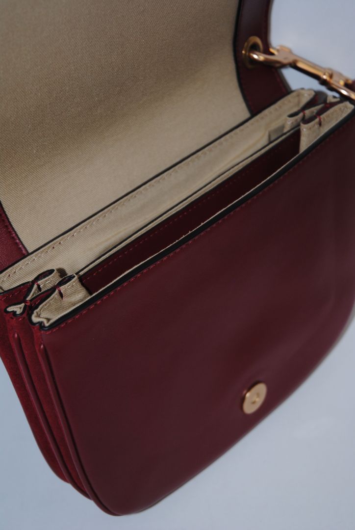 Body: Navy blue suede Trim & Strap: Burgundy and camel-toned smooth leather See by Chloe Hana Small Saddle Bag, Width: 7.5 in (19 cm) Height: 6.5 in (16.5 cm) Depth: 2.75 in (7 cm) Strap Drop: Adjustable up to approx. 22 in (crossbody length)