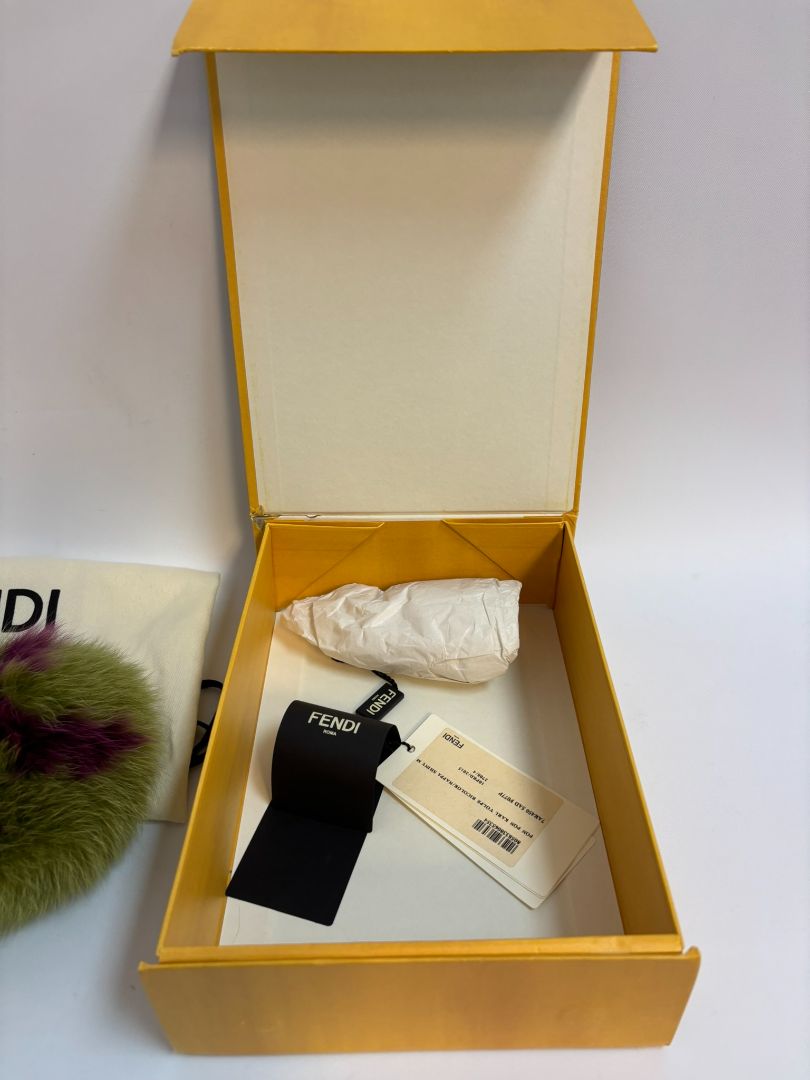purple and green FENDI fur “monster” bag charm, pom-pom diameter: 10 cm (4 in) Total hanging drop (ring + strap + fur): ~20 cm (8 in)