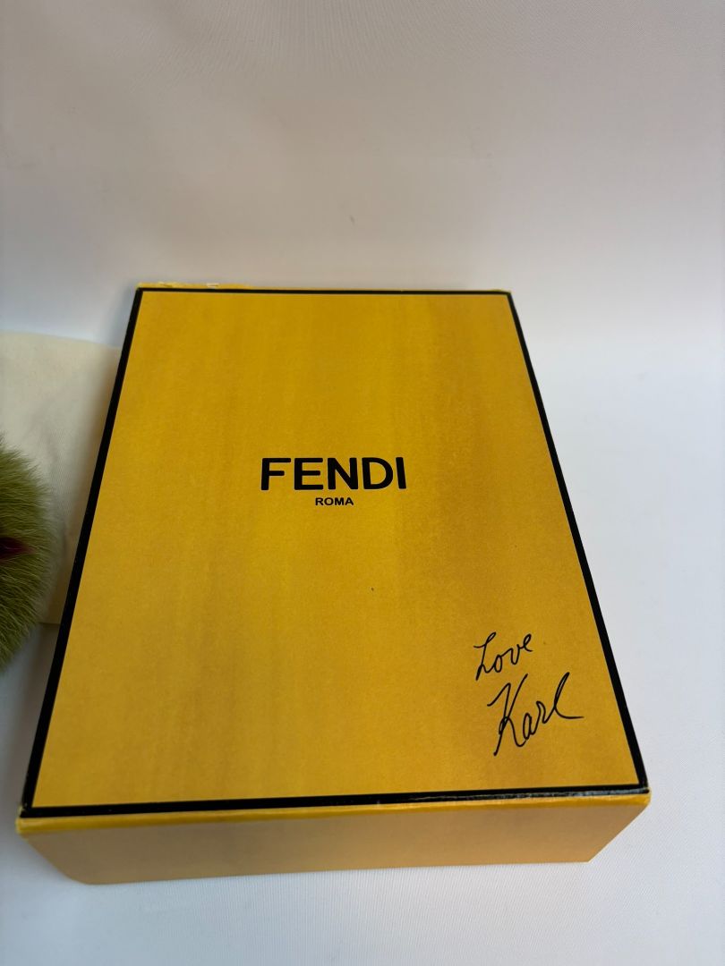 purple and green FENDI fur “monster” bag charm, pom-pom diameter: 10 cm (4 in) Total hanging drop (ring + strap + fur): ~20 cm (8 in)