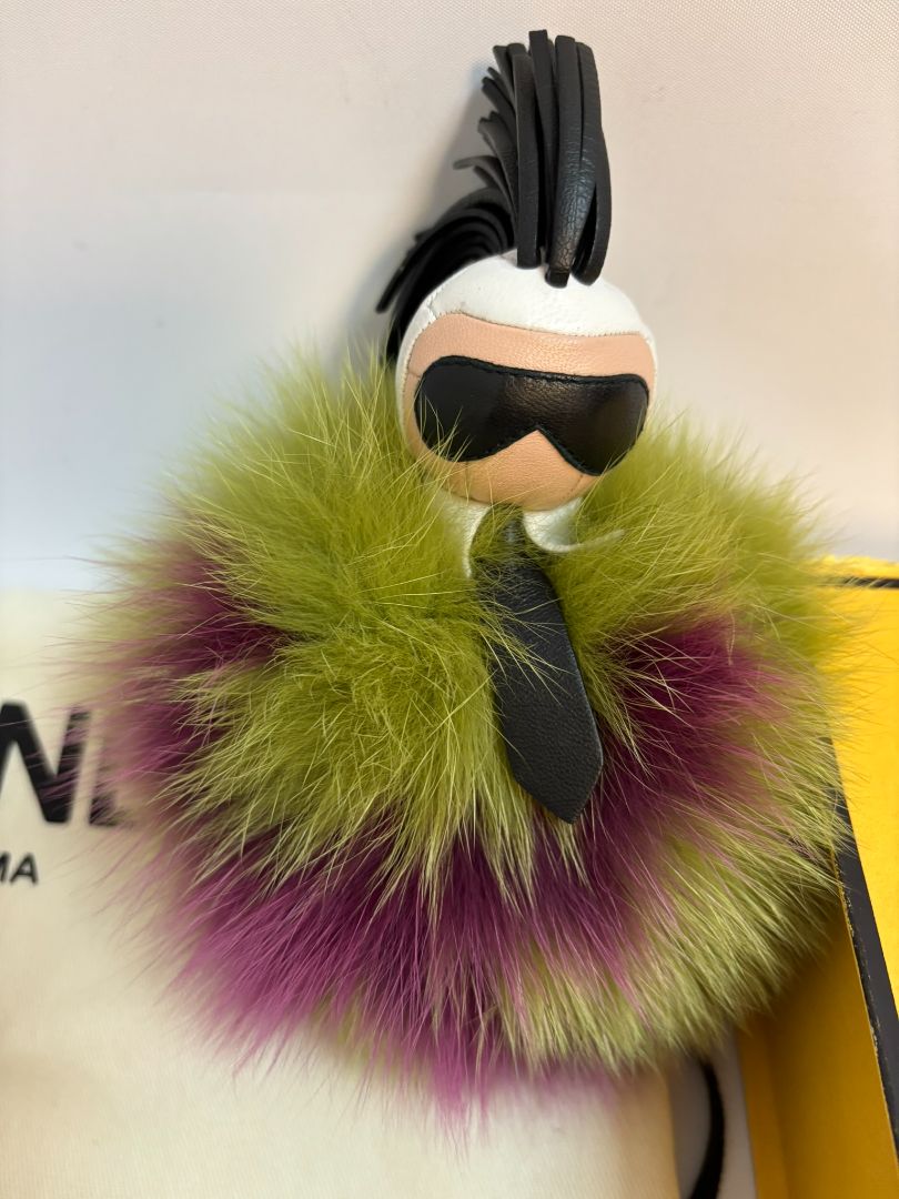 purple and green FENDI fur “monster” bag charm, pom-pom diameter: 10 cm (4 in) Total hanging drop (ring + strap + fur): ~20 cm (8 in)