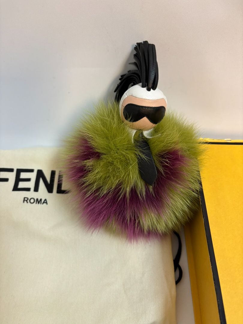 purple and green FENDI fur “monster” bag charm, pom-pom diameter: 10 cm (4 in) Total hanging drop (ring + strap + fur): ~20 cm (8 in)