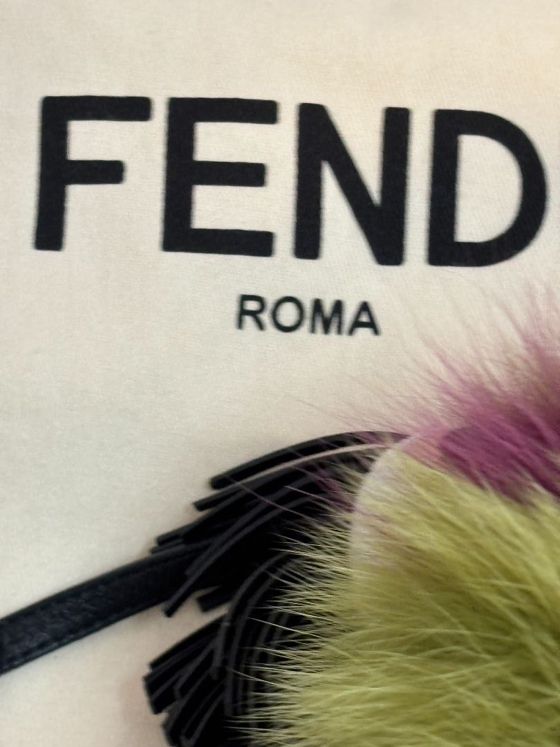 purple and green FENDI fur “monster” bag charm, pom-pom diameter: 10 cm (4 in) Total hanging drop (ring + strap + fur): ~20 cm (8 in)