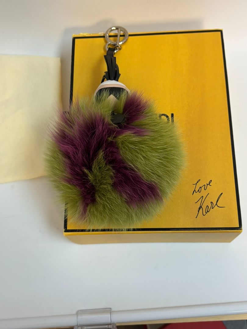 purple and green FENDI fur “monster” bag charm, pom-pom diameter: 10 cm (4 in) Total hanging drop (ring + strap + fur): ~20 cm (8 in)