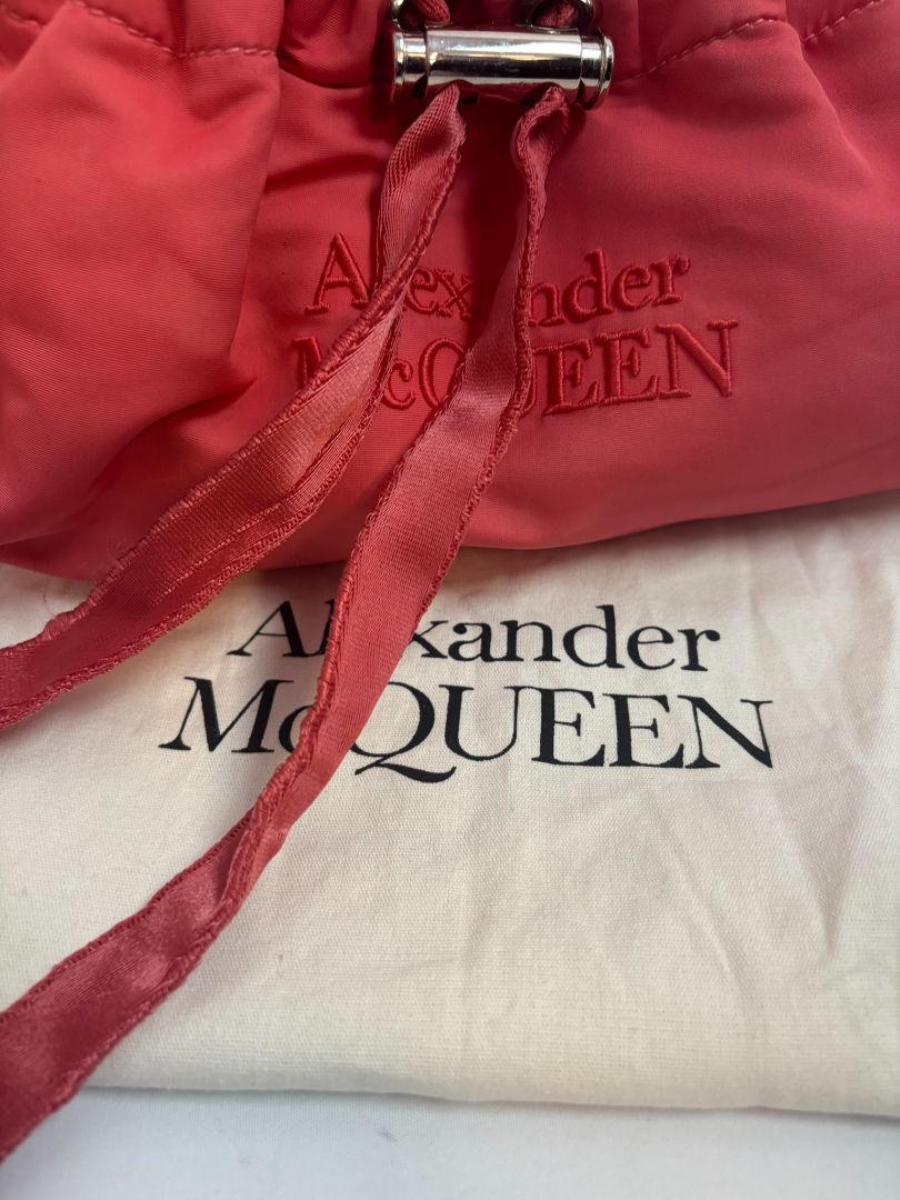 red Alexander McQueen drawstring bag, Length: 10 in Height: 6 in Depth: 3.5 in Strap Drop: Adjustable (approx. 12β20 in)