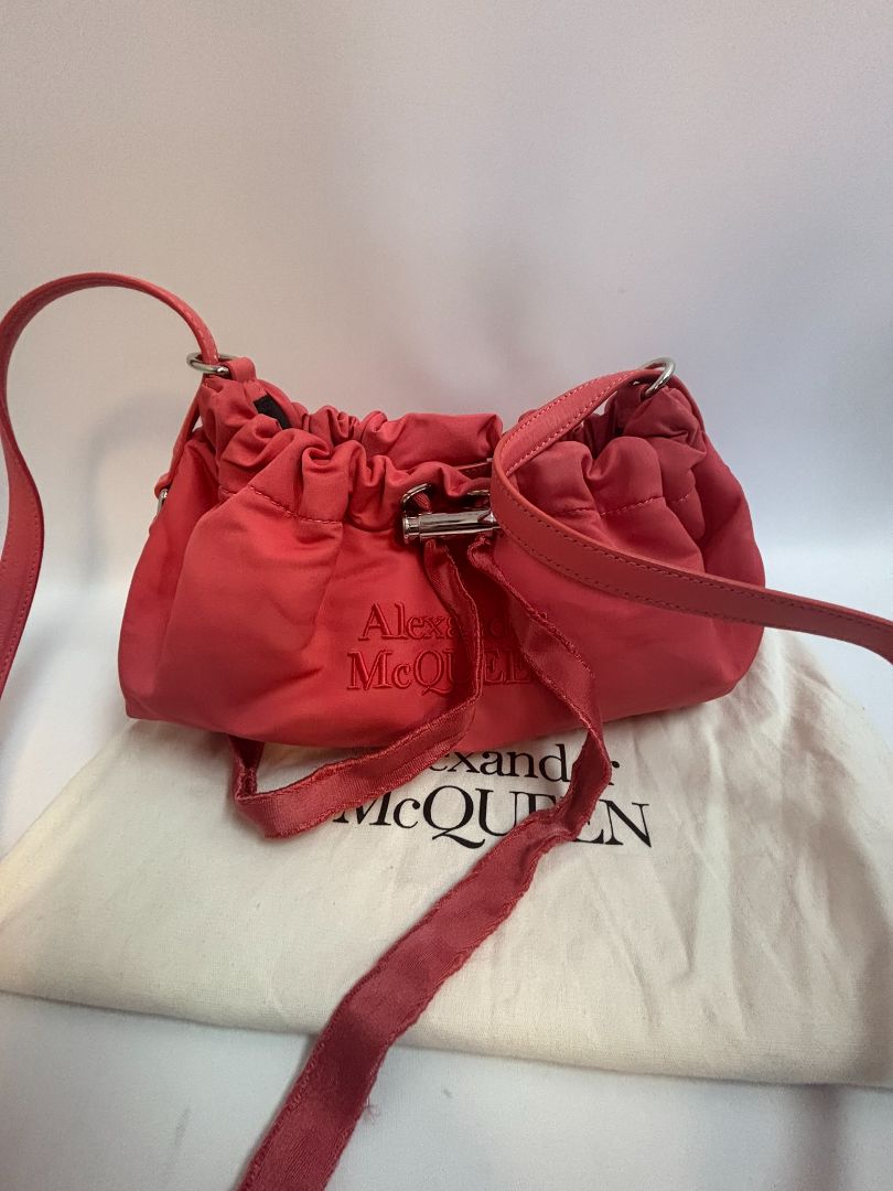 red Alexander McQueen drawstring bag, Length: 10 in Height: 6 in Depth: 3.5 in Strap Drop: Adjustable (approx. 12β20 in)