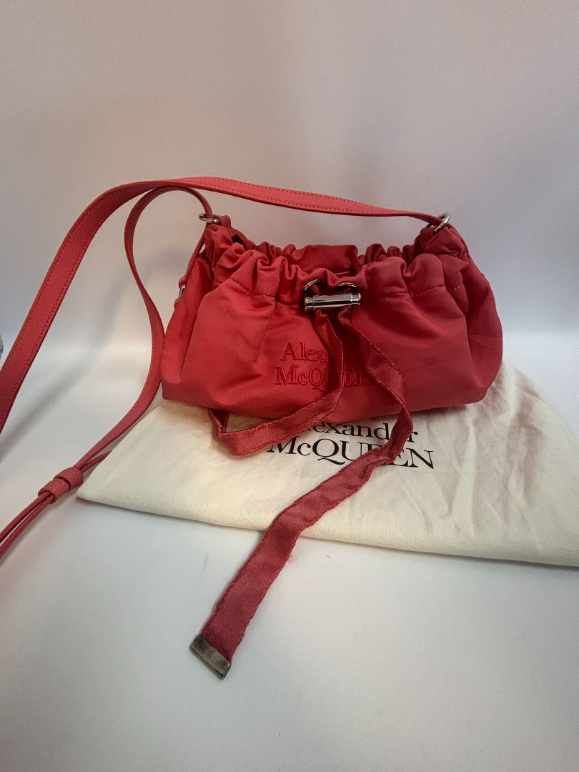 red Alexander McQueen drawstring bag, Length: 10 in Height: 6 in Depth: 3.5 in Strap Drop: Adjustable (approx. 12β20 in)