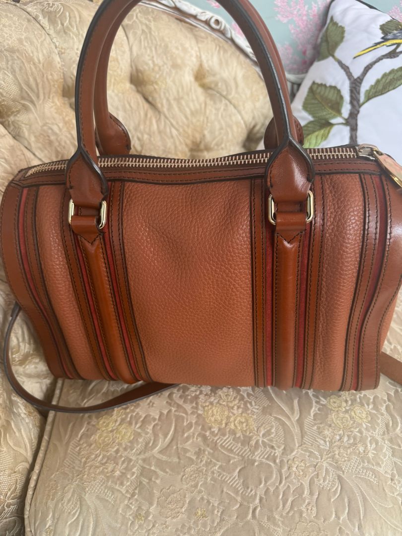 Cognac brown with multi-stripe accents in oxblood, black, and tan (subtle nod to Burberry’s house check palette) Burberry Model: Likely from the Banner or Orchard satchel line (structured silhouette with rolled handles and stripe accents), Length: 13 in (