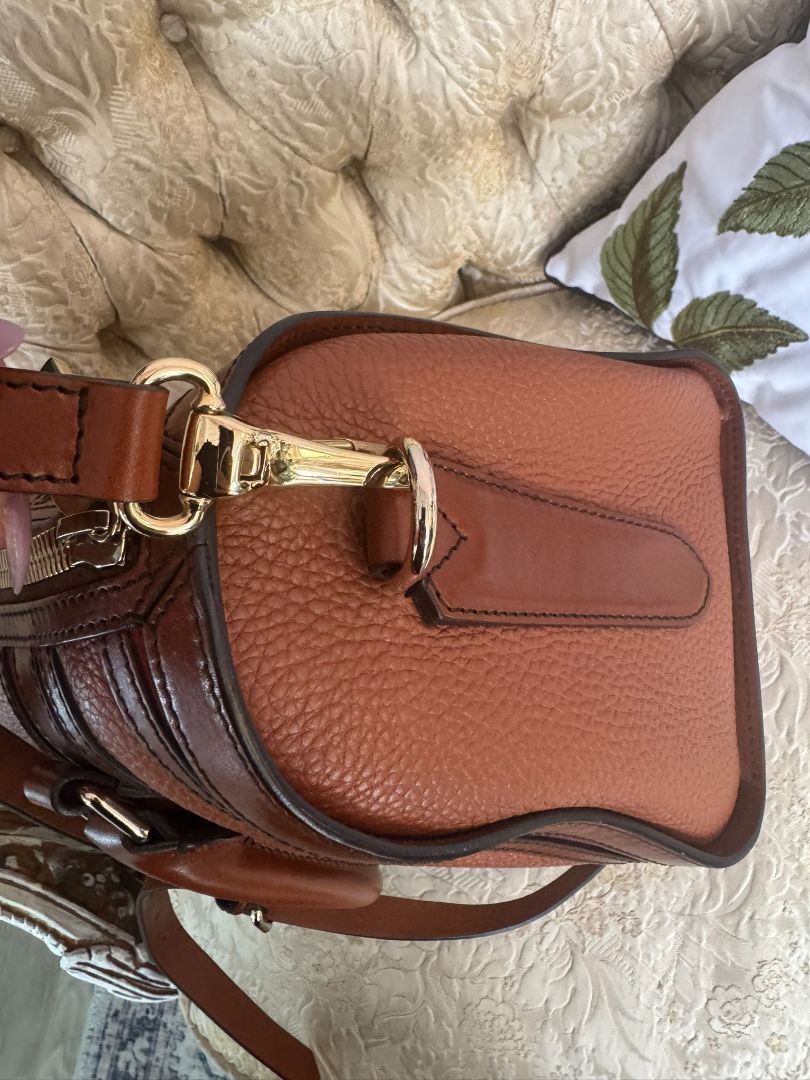 Cognac brown with multi-stripe accents in oxblood, black, and tan (subtle nod to Burberry’s house check palette) Burberry Model: Likely from the Banner or Orchard satchel line (structured silhouette with rolled handles and stripe accents), Length: 13 in (