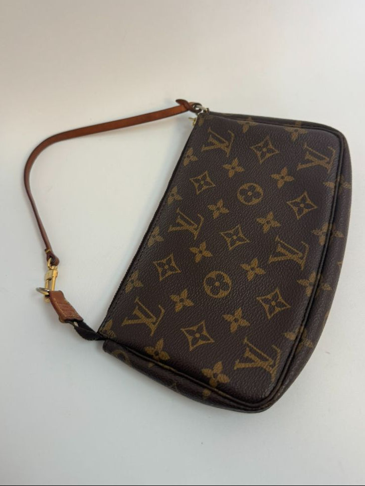 Louis Vuitton Pochette Monogram clutch bag with iconic brown monogram canvas and gold-tone hardware.