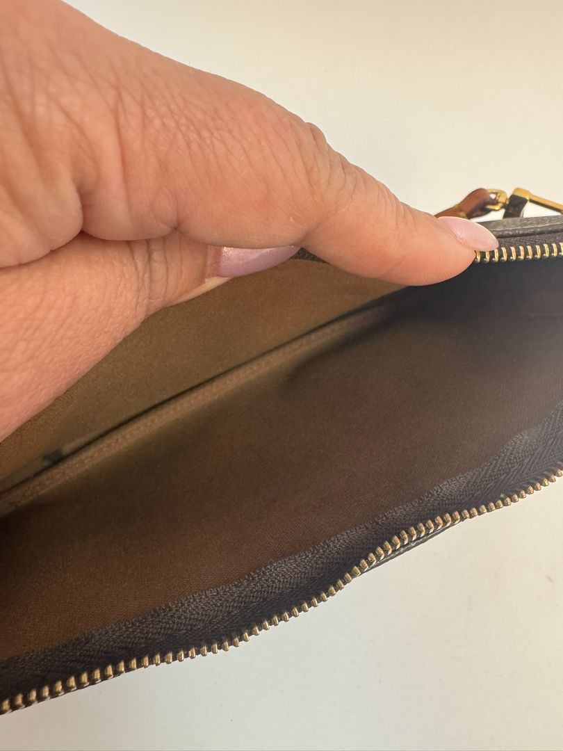 Louis Vuitton Pochette Monogram clutch bag with iconic brown monogram canvas and gold-tone hardware.