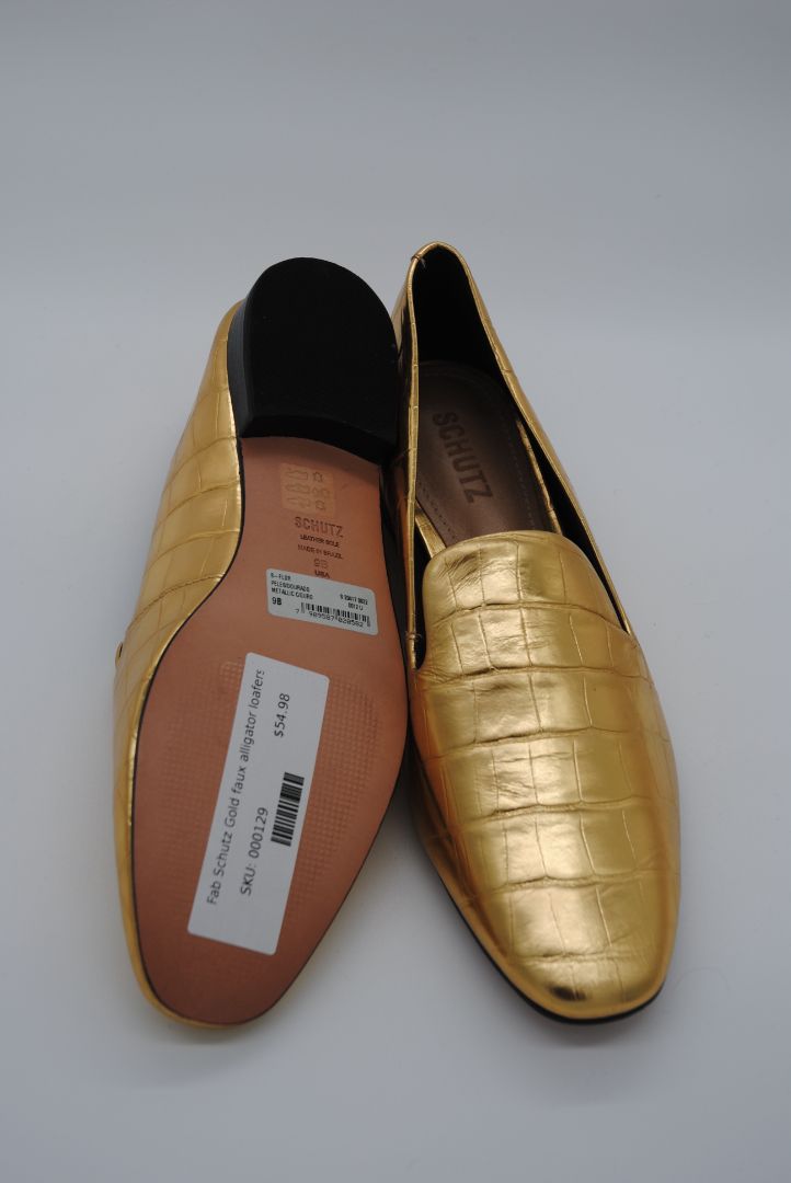 Gold SCHUTZ loafers with textured leather design.