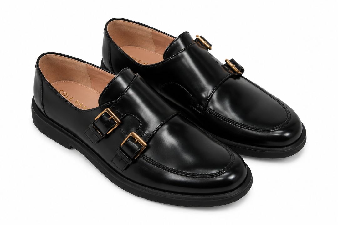 black and gold Cole Haan loafers with buckle