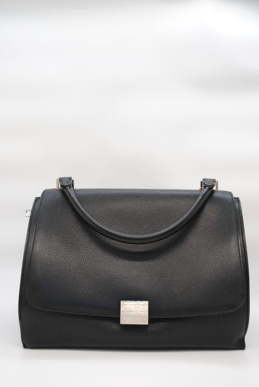 Céline Trapeze tote in black drummed calfskin with top handle, front flap closure, winged sides, and gold-tone hardware.