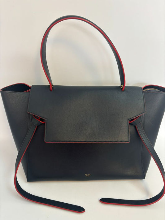 Celine Paris Leather Mini Belt Bag in navy blue and red, crafted from premium leather. Features a sleek, compact design with a gold-tone buckle closure, adjustable leather strap for crossbody or belt wear, and the iconic Celine logo embossed on the front.