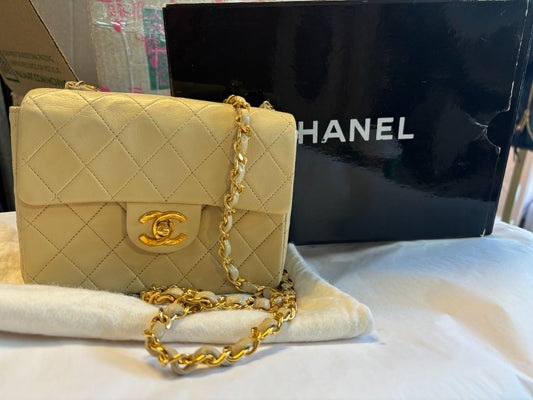 Chanel Lambskin Quilted Mini Pearl Crush Flap Bag in black with gold-tone hardware and adjustable pearl-accented chain strap.