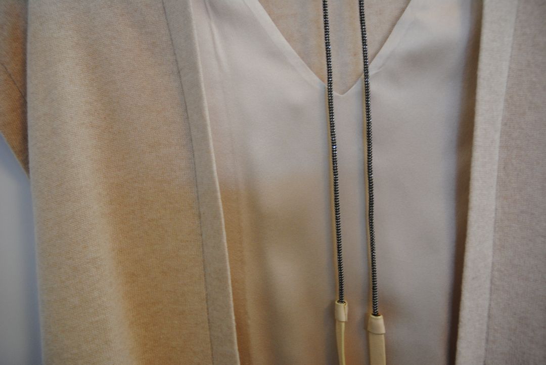 beige Brunello Cucinelli cashmere and silk belted top, Bust (flat): 19 in Length (shoulder to hem): 26 in (front), 24.5 in (back) Shoulder Width: 17 in Fit: Relaxed, draped silhouette Closure: Open front with inner satin tie detail