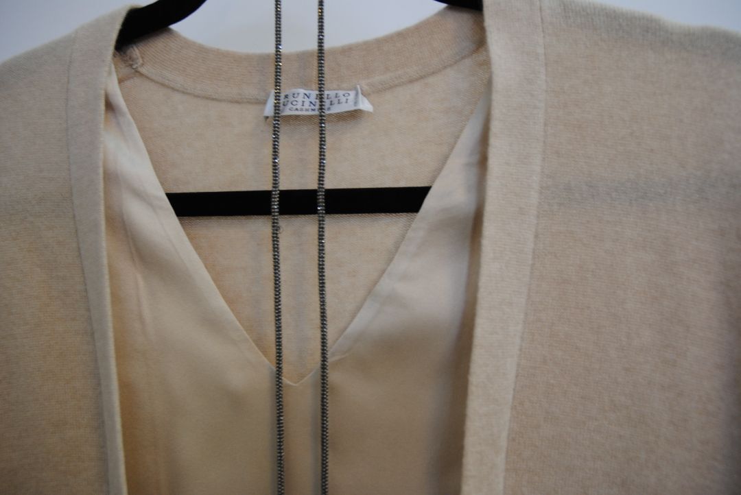 beige Brunello Cucinelli cashmere and silk belted top, Bust (flat): 19 in Length (shoulder to hem): 26 in (front), 24.5 in (back) Shoulder Width: 17 in Fit: Relaxed, draped silhouette Closure: Open front with inner satin tie detail